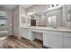 Bathroom with dual sinks, large mirrors, and a walk-in closet at 16848 Canopy Garden Dr, Port Charlotte, FL 33953