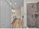Bathroom showcases a tiled shower, closet, and vanity with hard wood floors at 16848 Canopy Garden Dr, Port Charlotte, FL 33953