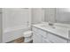 Bathroom featuring a shower-tub combo, tile surround, and vanity with drawers at 16848 Canopy Garden Dr, Port Charlotte, FL 33953