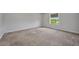 Bedroom with a window and neutral-colored carpet, with gray baseboards at 16848 Canopy Garden Dr, Port Charlotte, FL 33953