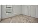 Bedroom featuring window, neutral walls, and carpet flooring at 16848 Canopy Garden Dr, Port Charlotte, FL 33953