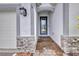 Close-up of the front door entrance showing stone and brick accents, covered entryway at 16848 Canopy Garden Dr, Port Charlotte, FL 33953