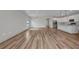 Spacious living room featuring wood floors and modern lighting fixtures at 16848 Canopy Garden Dr, Port Charlotte, FL 33953