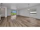 Open concept living room with wood floors and sliding glass doors to the patio at 16848 Canopy Garden Dr, Port Charlotte, FL 33953
