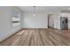 Bright living room with wood floors and large window, modern lighting fixtures at 16848 Canopy Garden Dr, Port Charlotte, FL 33953
