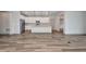Open-concept kitchen and living room area with lots of space and wood flooring at 16848 Canopy Garden Dr, Port Charlotte, FL 33953