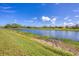 Grassy backyard with a gorgeous lake view at 1775 Scarlett Ave, North Port, FL 34289