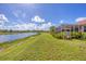 Backyard of home with an amazing view of the lake and gorgeous landscaping at 1775 Scarlett Ave, North Port, FL 34289