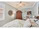 Light-filled bedroom with a wooden armoire, shuttered windows, and a ceiling fan at 1775 Scarlett Ave, North Port, FL 34289