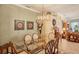 Formal dining area with large glass table and decorative art, and a view into the living room at 1775 Scarlett Ave, North Port, FL 34289