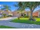 Inviting front yard with manicured lawn, palm trees and charming curb appeal at 1775 Scarlett Ave, North Port, FL 34289