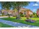 Beautifully landscaped front yard with mature trees, lush greenery and inviting walkway at 1775 Scarlett Ave, North Port, FL 34289