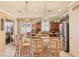 Bright eat-in kitchen featuring custom wood cabinetry, granite counters, stainless appliances, and pendant lighting at 1775 Scarlett Ave, North Port, FL 34289