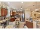 Modern eat-in kitchen with stainless appliances, granite countertops, and a view into the dining area at 1775 Scarlett Ave, North Port, FL 34289