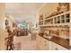 Bright living room with built-in wine bar, seating and views into the lanai, living room, and dining area at 1775 Scarlett Ave, North Port, FL 34289