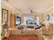 Bright living room with large window overlooking the backyard and comfortable seating at 1775 Scarlett Ave, North Port, FL 34289