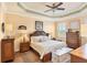 Spacious primary bedroom featuring a tray ceiling, wood floors, and neutral paint at 1775 Scarlett Ave, North Port, FL 34289