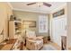 Cozy home office features a recliner, built-in shelves, and a desk with natural light at 1775 Scarlett Ave, North Port, FL 34289