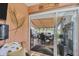 Covered patio features outdoor dining, a lake view, and a tranquil waterfront setting at 1775 Scarlett Ave, North Port, FL 34289