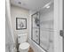 Clean bathroom featuring a toilet, bathtub with shower, and a fresh white towel at 19505 Quesada Ave # Vv201, Port Charlotte, FL 33948