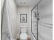 Well-lit bathroom featuring a toilet, bathtub with shower, and a fresh white towel hanging at 19505 Quesada Ave # Vv201, Port Charlotte, FL 33948