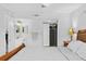 Bright bedroom showcasing a partial view of the bed, closet, and ensuite bathroom at 19505 Quesada Ave # Vv201, Port Charlotte, FL 33948
