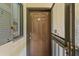 Condo unit entrance showcasing a solid door with a security peephole and a partially visible window at 19505 Quesada Ave # Vv201, Port Charlotte, FL 33948