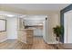 Kitchen and breakfast bar featuring white appliances and stone counter tops with light wood flooring at 19505 Quesada Ave # Vv201, Port Charlotte, FL 33948