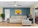 Cozy living room with a comfortable sofa, ceiling fan, and sliding doors leading to outdoor space at 19505 Quesada Ave # Vv201, Port Charlotte, FL 33948