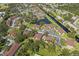 Bird's eye view of community featuring buildings, parking areas, a pond, and surrounding lush green spaces at 19505 Quesada Ave # Vv201, Port Charlotte, FL 33948