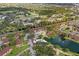 Community aerial view showing buildings, parking, a swimming pool and a pond with landscaping and peaceful atmosphere at 19505 Quesada Ave # Vv201, Port Charlotte, FL 33948