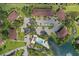 Community aerial view featuring buildings, parking, a swimming pool and a pond showcasing the landscaping and tranquil atmosphere at 19505 Quesada Ave # Vv201, Port Charlotte, FL 33948