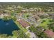 Aerial view of community with meticulously landscaped grounds, parking, and a serene pond, offering a tranquil residential setting at 19505 Quesada Ave # Vv201, Port Charlotte, FL 33948