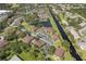 An aerial view showing a community with multiple buildings, parking areas, a serene pond, and surrounding green spaces at 19505 Quesada Ave # Vv201, Port Charlotte, FL 33948