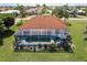 Aerial view of the home showcasing the tile roof, screened-in pool, and landscaped backyard at 2105 Deborah Dr, Punta Gorda, FL 33950