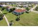 High angle view of the property with tile roof, pool, mature landscaping, and lawn at 2105 Deborah Dr, Punta Gorda, FL 33950