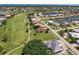 High angle image of houses with tile roofs, located near a golf course and canals at 2105 Deborah Dr, Punta Gorda, FL 33950