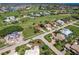 An aerial view of the homes near a golf course and water in a sunny community at 2105 Deborah Dr, Punta Gorda, FL 33950