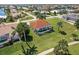 Elevated view of home, tile roof, screened-in pool, landscaped yard, palm trees, and walkway at 2105 Deborah Dr, Punta Gorda, FL 33950