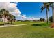 Expansive backyard featuring a walkway, palm trees, and plenty of space for outdoor activities at 2105 Deborah Dr, Punta Gorda, FL 33950