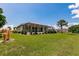 Landscaped backyard with spacious lawn and screened-in lanai, perfect for outdoor living at 2105 Deborah Dr, Punta Gorda, FL 33950
