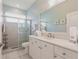 Bright bathroom featuring a glass shower and vanity with white cabinets at 2105 Deborah Dr, Punta Gorda, FL 33950