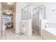 Light-filled bathroom with glass shower and tub, with view to bedroom at 2105 Deborah Dr, Punta Gorda, FL 33950
