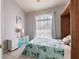 Comfortable bedroom with a flamingo patterned bedspread, arched window and built-in cabinet at 2105 Deborah Dr, Punta Gorda, FL 33950