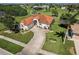 Aerial view of a home with a tile roof, long driveway, and lush landscaping on a sunny day at 2105 Deborah Dr, Punta Gorda, FL 33950