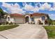 Home with a tile roof, attached garage, and a curved driveway leading to the entrance at 2105 Deborah Dr, Punta Gorda, FL 33950