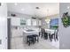Bright kitchen with white cabinets, stainless steel appliances, and a cozy dining area at 2105 Deborah Dr, Punta Gorda, FL 33950