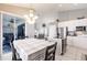 Bright kitchen and dining area featuring white cabinets and stainless steel appliances at 2105 Deborah Dr, Punta Gorda, FL 33950