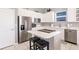 Kitchen with white cabinetry, island cooktop, and stainless-steel appliances at 2105 Deborah Dr, Punta Gorda, FL 33950
