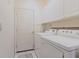 Functional laundry room with washer, dryer, and white cabinets at 2105 Deborah Dr, Punta Gorda, FL 33950